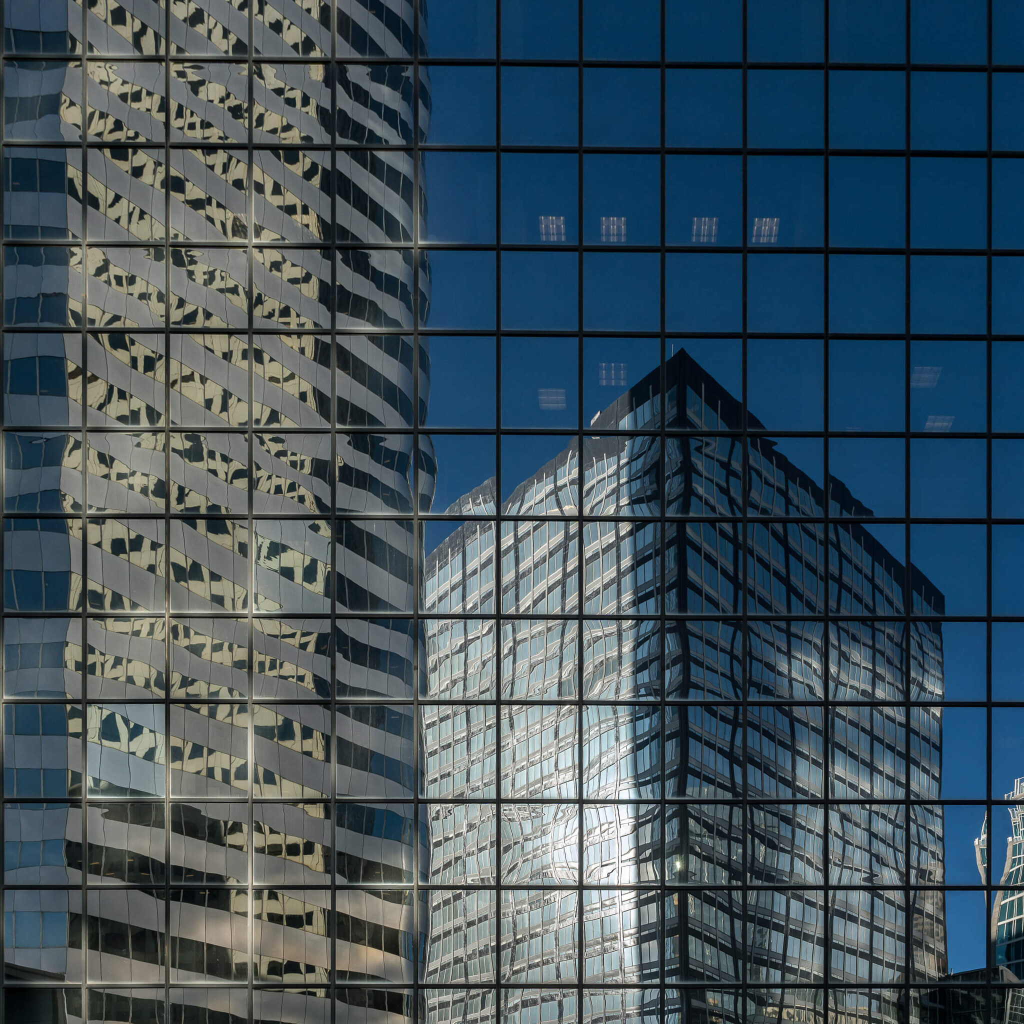 Skyscraper Reflections on Glass Façade
