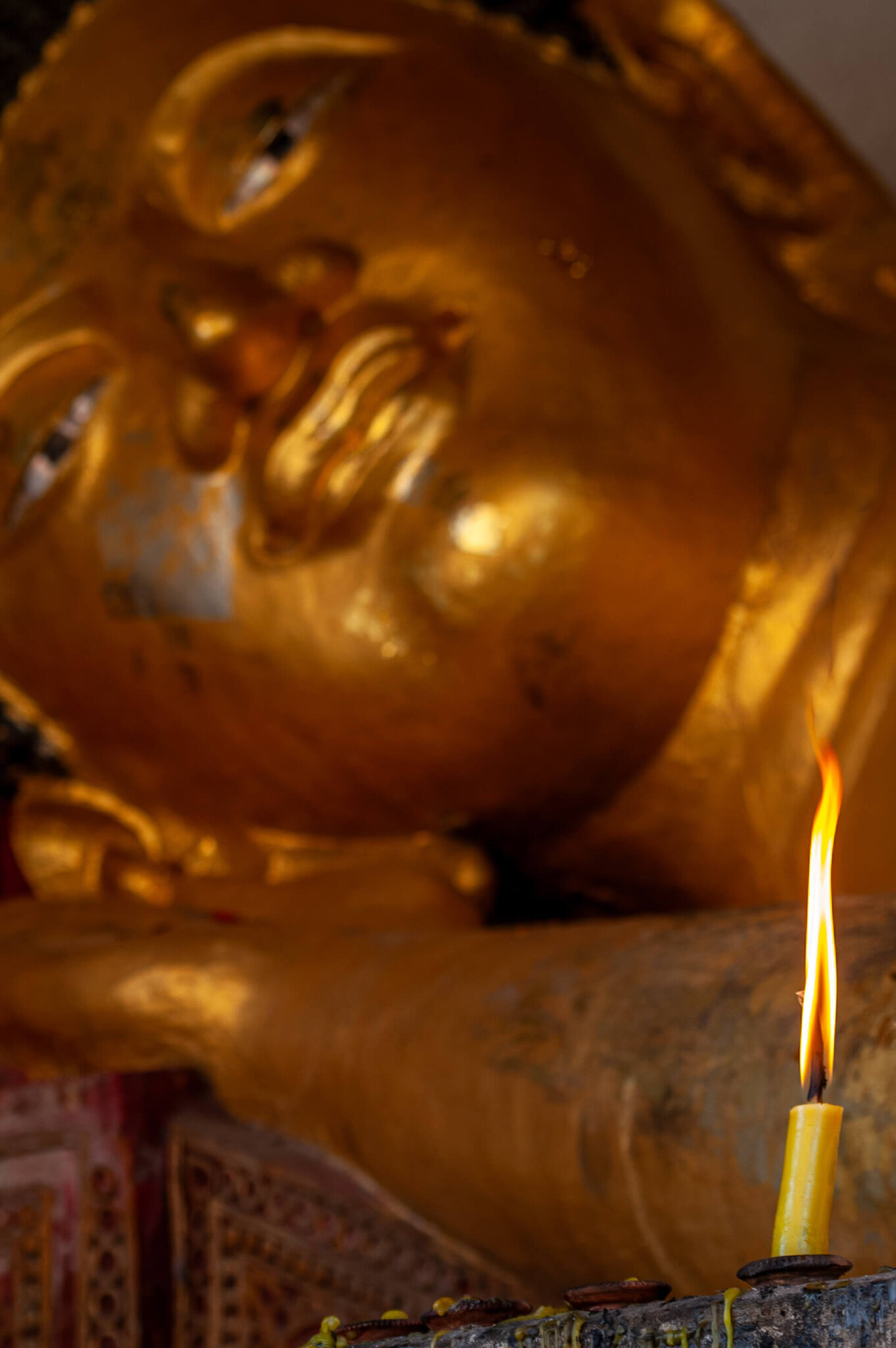 Reclining Buddha and Votive Flame