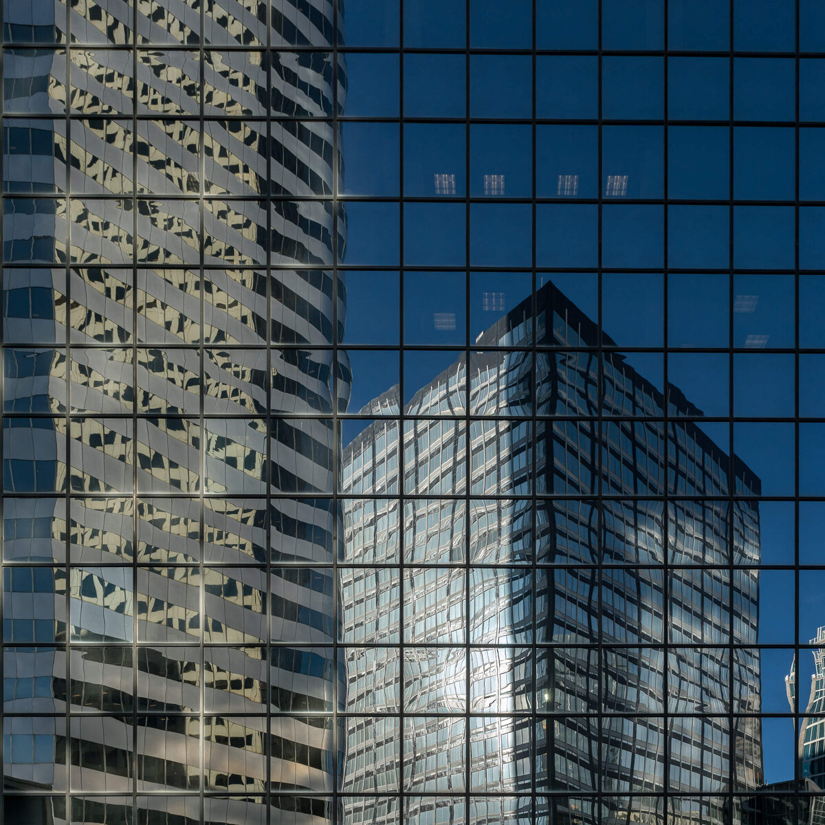 Skyscraper Reflections on Glass Façade